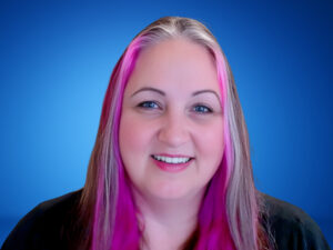 A photograph of Melanie Schlotterbeck against a blue background.